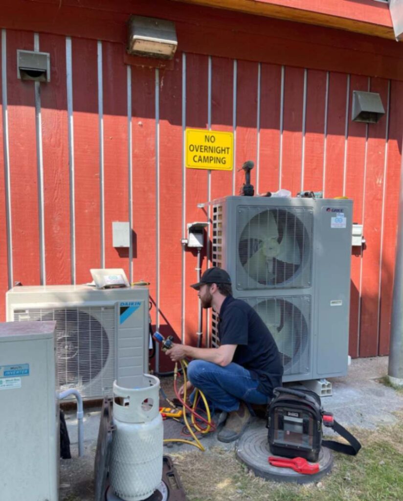 Technician Fixing the Air Conditioner problems